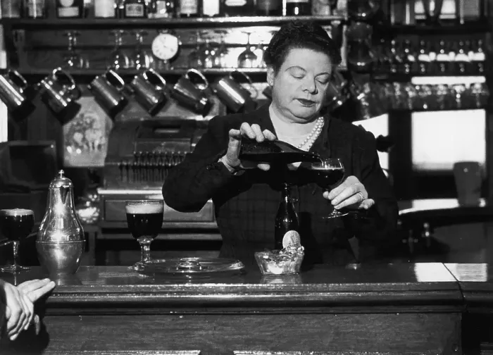 Framed Print : Barmaid. A barmaid pours out a glass of beer Framed Print : Barmaid. A barmaid pours out a glass of beer