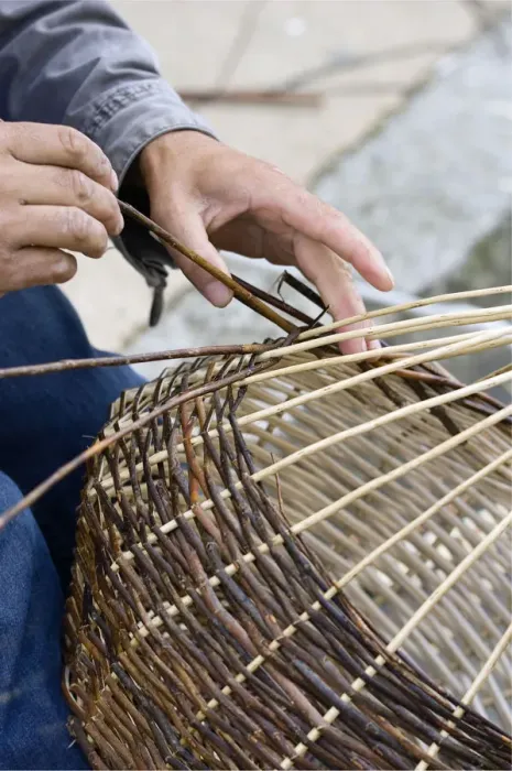 Framed Print : A basket weaver sitting on the street and weaving a basket, Brittany, France, Europe Framed Print : A basket weaver sitting on the street and weaving a basket, Brittany, France, Europe