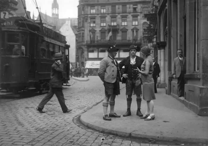 Framed Print : Bavarians. circa 1930: A fashionable woman talks to a couple of men in Framed Print : Bavarians. circa 1930: A fashionable woman talks to a couple of men in