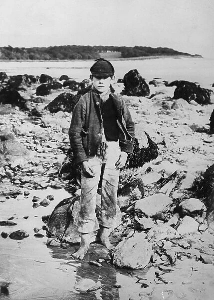 Beach Boy. 1891: A barefooted youth on the beach at Lassieborn in Ireland