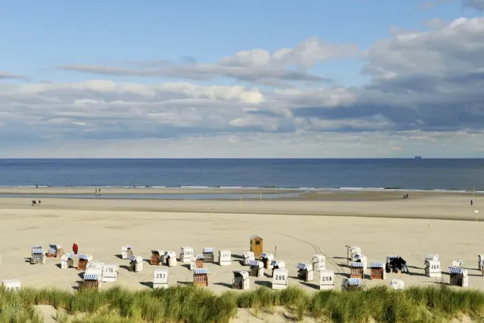 Framed Print : Beach with chair beach, North Sea with a cloudy sky, Spiekeroog, East Frisia, Lower Saxony, Germany Framed Print : Beach with chair beach, North Sea with a cloudy sky, Spiekeroog, East Frisia, Lower Saxony, Germany