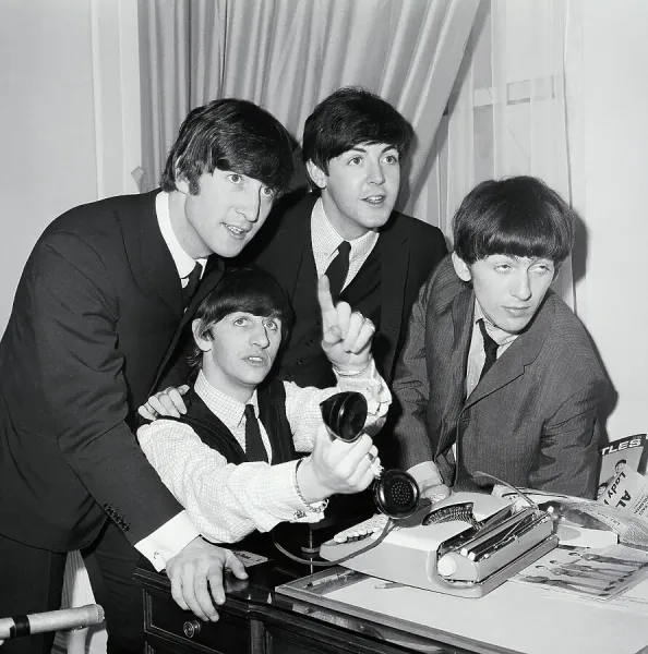 The Beatles Gather Around Phone in Hotel Room Print, 1964. Art