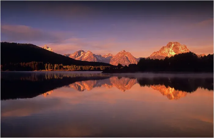 Framed Print : A beautiful coloured dawn casts its glow over Jackson lake in the Grand Tetons, Wyoming Framed Print : A beautiful coloured dawn casts its glow over Jackson lake in the Grand Tetons, Wyoming