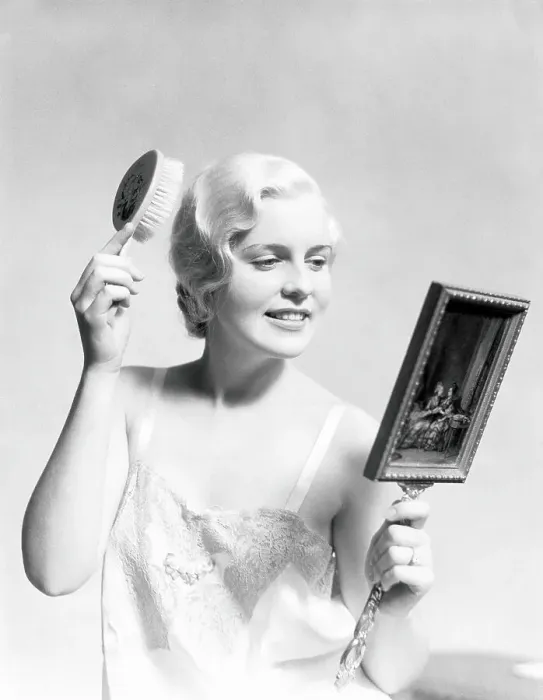 Framed Print : Beautiful woman wearing slip, looking in mirror and brushing hair Framed Print : Beautiful woman wearing slip, looking in mirror and brushing hair