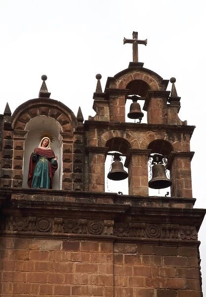 Bell tower and statue on roof of temple, Cusco