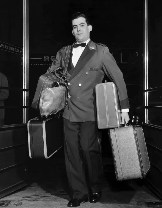 Framed Print : Bellhop Carrying Luggage Framed Print : Bellhop Carrying Luggage