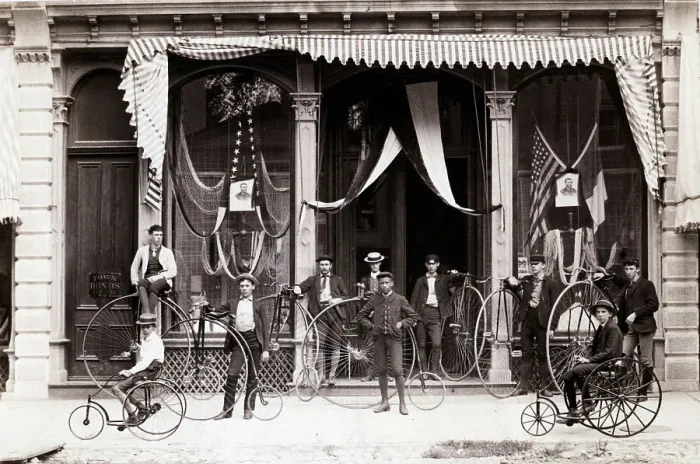 Framed Print : Bicyclists Posed In Front Of Draped Buil Framed Print : Bicyclists Posed In Front Of Draped Buil