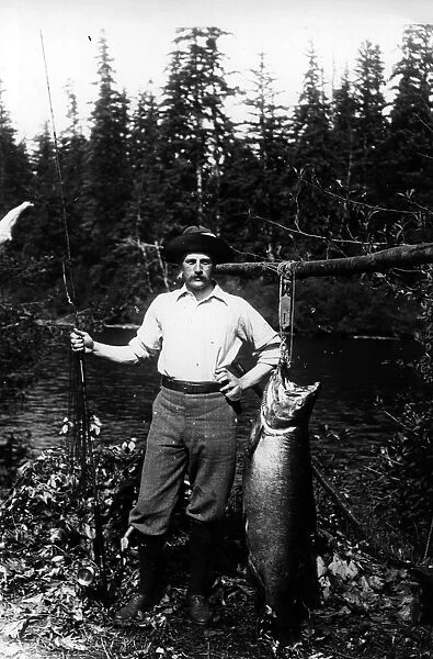 Big Catch. circa 1895: A fisherman proudly displays his catch In British Colombia, Canada
