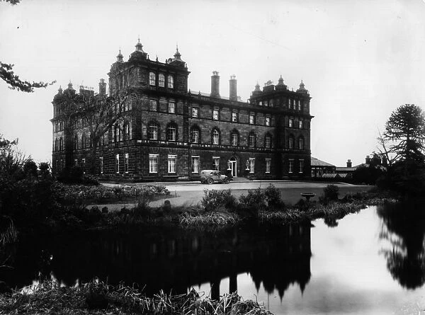 Big House. circa 1930: A large house, partly reflected in water