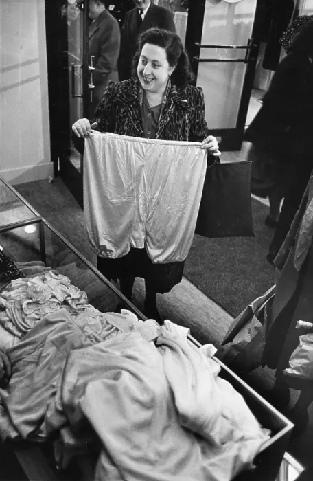 Framed Print : Big Pants. A woman holding up a large pair of knickers at the opening of Framed Print : Big Pants. A woman holding up a large pair of knickers at the opening of