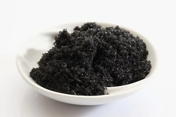 Black Hawaiian sea salt in a small porcelain bowl