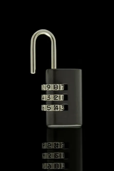 Framed Print : Black unlocked combination lock on black