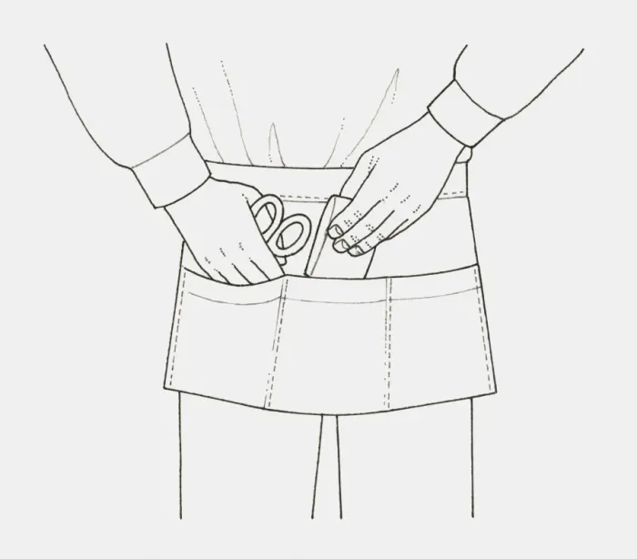 Framed Print : Black and white illustration of an apron with pockets, holding small items like scissors