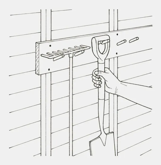 Framed Print : Black and white illustration of hand hanging garden spade next to rake on hooks in a shed Framed Print : Black and white illustration of hand hanging garden spade next to rake on hooks in a shed