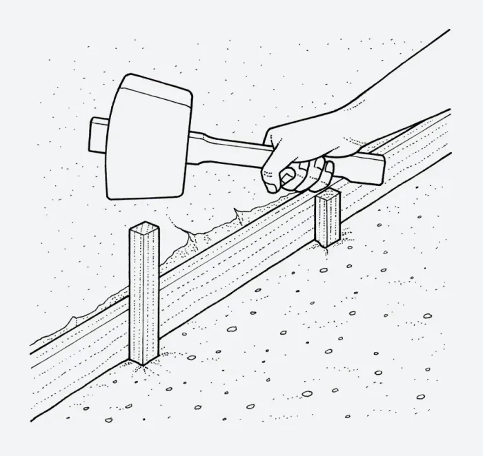 Framed Print : Black and white illustration of hand holding mallet above wooden edging post in ground Framed Print : Black and white illustration of hand holding mallet above wooden edging post in ground