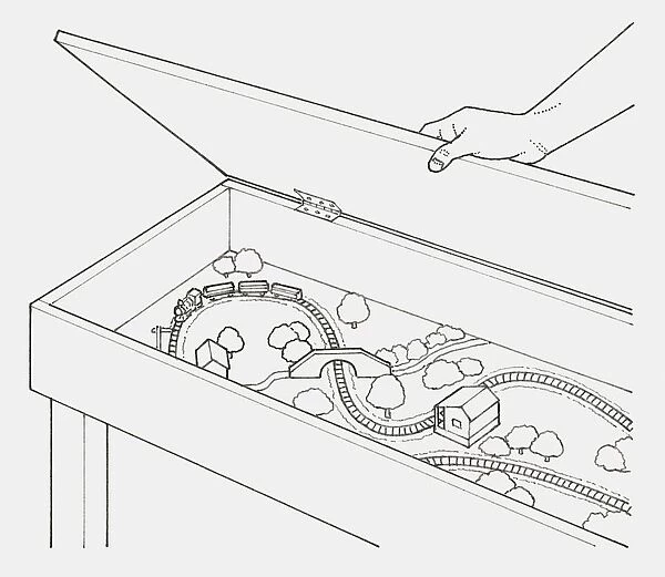 Black and white illustration of hand opening lid of a box containing a train set