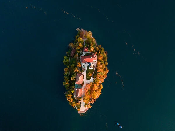 Bled Lake with Pilgrimage Church of the Assumption of Maria at sunrise. Aerial view