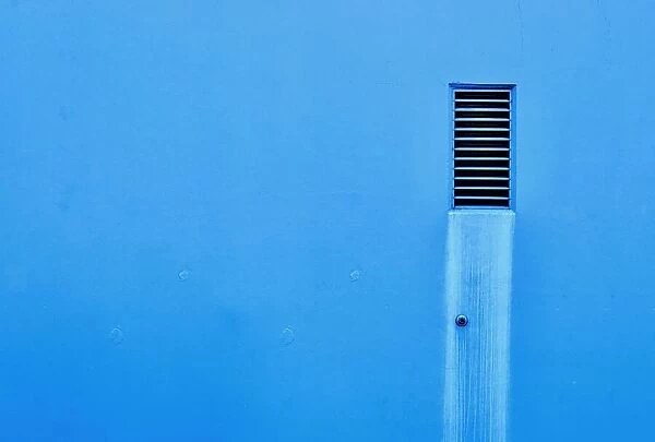 Blue Vent. A color photo of a vent on a wall to a commercial building in Portland, Oregon
