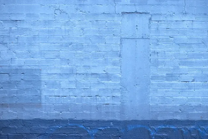 Framed Print : Blue Wall. A color photograph of the wall to an aging commercial building