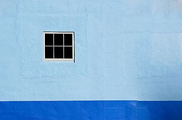 Two Blues. A color photo of the wall to a commercial building in Astoria