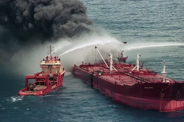 Framed Print : Boat Pours Water On Burning Oil Tanker Framed Print : Boat Pours Water On Burning Oil Tanker