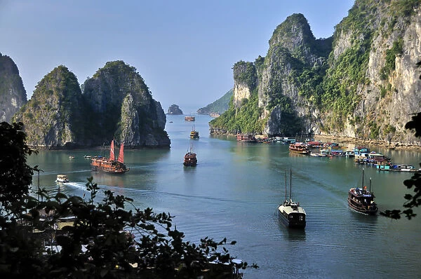 Boats and junks in Halong Bay, karst mountains in the sea, Vietnam, Asia