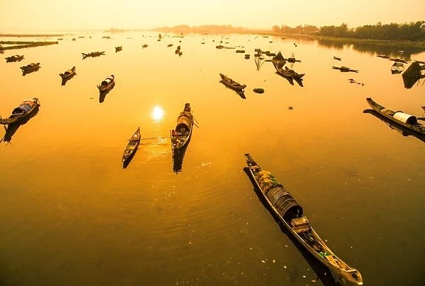 Boats in Tam Giang lagoon in sunrise from drone. Hue, Vietnam