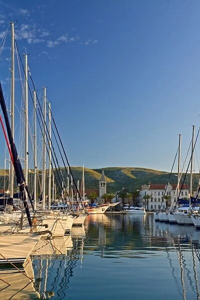 Boats in Trogir harbor at sunrise in Croatia