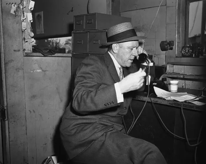 Framed Print : Bob Considine Sitting and Talking on Phone