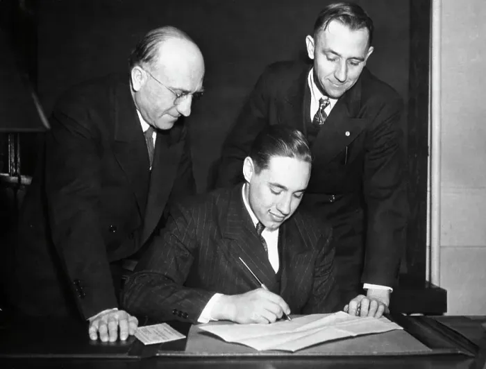 Framed Print : Bob Feller Signs Contract;Men Look On Framed Print : Bob Feller Signs Contract;Men Look On