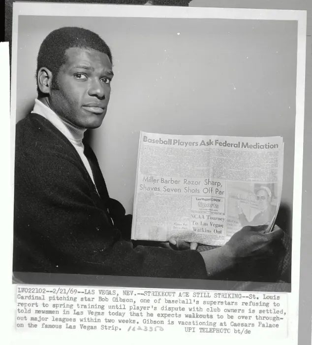 Framed Print : Bob Gibson Holding Newspaper Framed Print : Bob Gibson Holding Newspaper