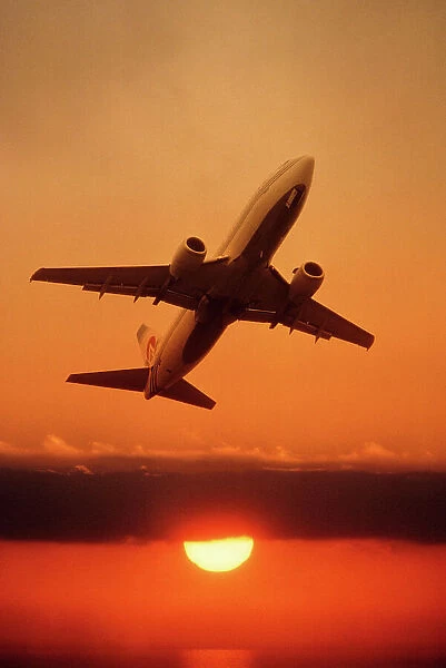 Boeing 737 taking off at sunset