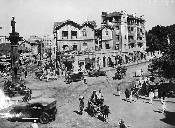 Bombay. A road junction in Bombay, west India, with cars and horse drawn traps
