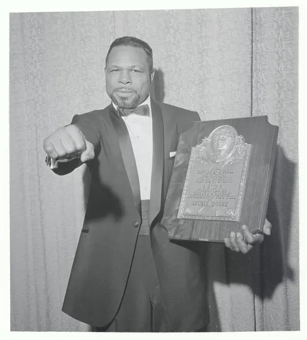 Framed Print : Boxer Archie Moore Making Fist and Holding Plaque