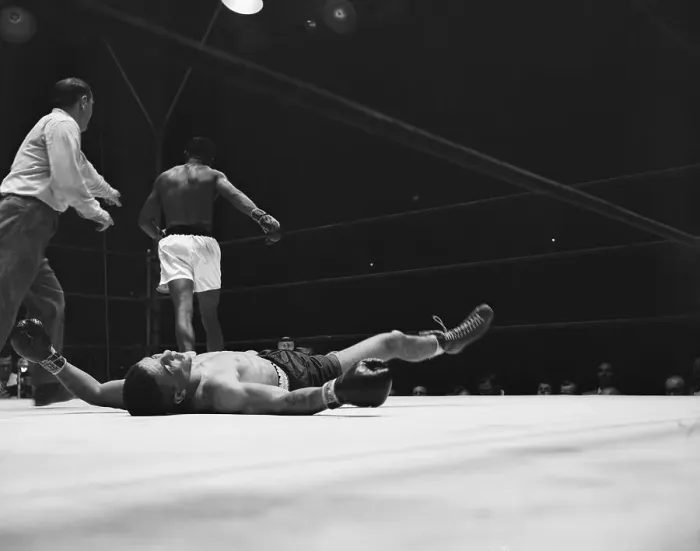 Framed Print : Boxer on Ground as Ray Robinson Walks Away