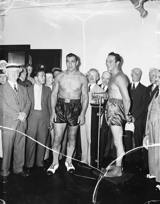 Framed Print : Boxer Max Baer Weighs In as Boxer Primo Carnera Watches Framed Print : Boxer Max Baer Weighs In as Boxer Primo Carnera Watches