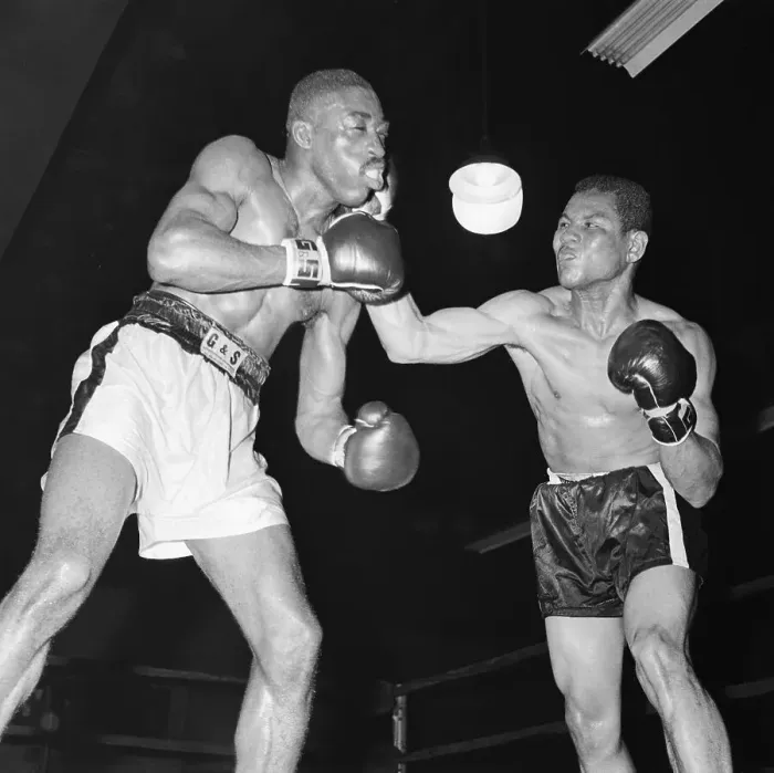 Framed Print : Boxer Takes Hard Right Punch From Oppone