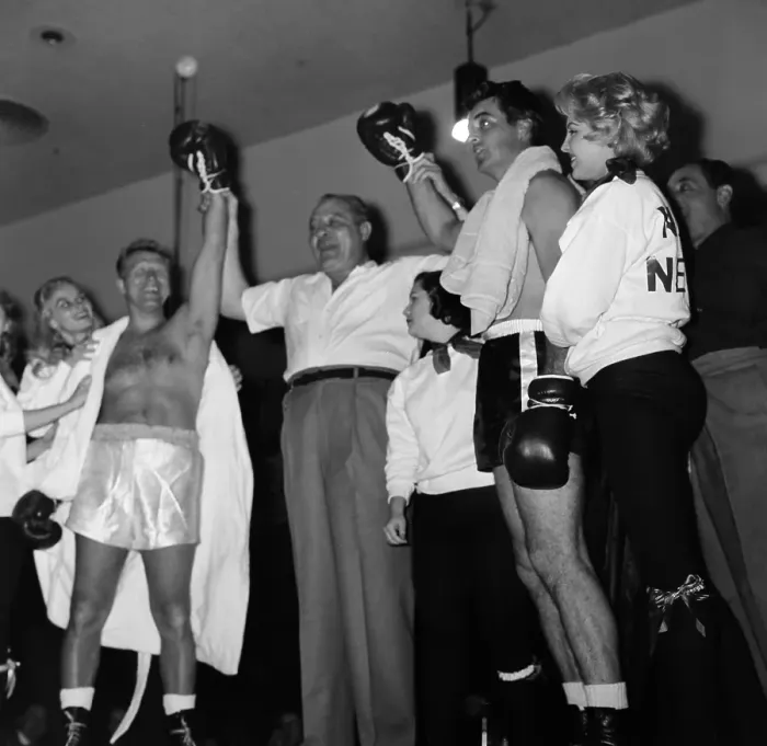 Framed Print : Boxing. LOS ANGELES, CA - CIRCA 1957: A ring judge holds up the hands of Framed Print : Boxing. LOS ANGELES, CA - CIRCA 1957: A ring judge holds up the hands of