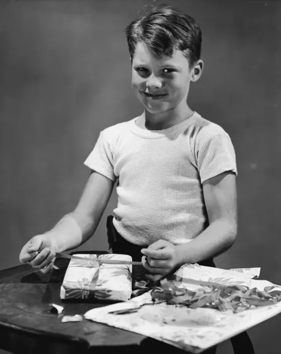 Framed Print : Boy (11-13) wrapping gift, portrait (B&W) Framed Print : Boy (11-13) wrapping gift, portrait (B&W)