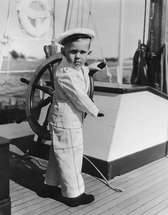Framed Print : Boy (4-5) playing with yacht helm Framed Print : Boy (4-5) playing with yacht helm