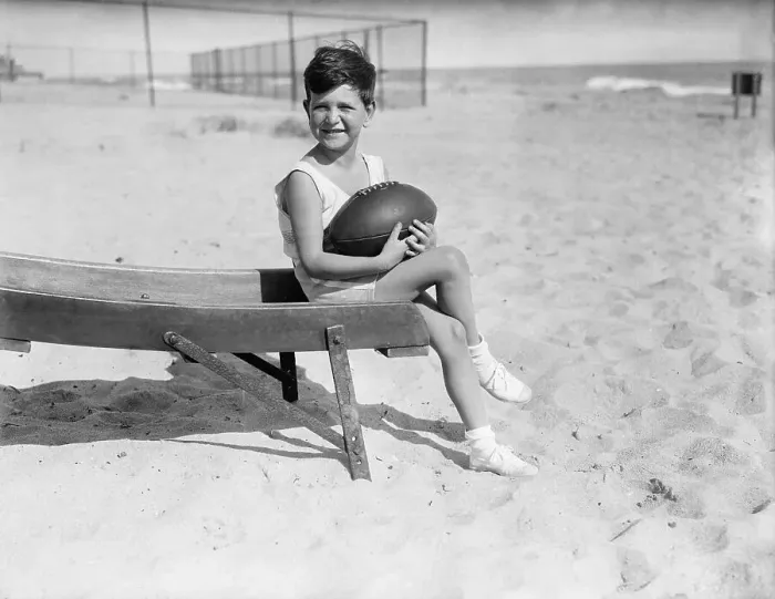 Framed Print : Boy (6-7) with ball sitting on beach