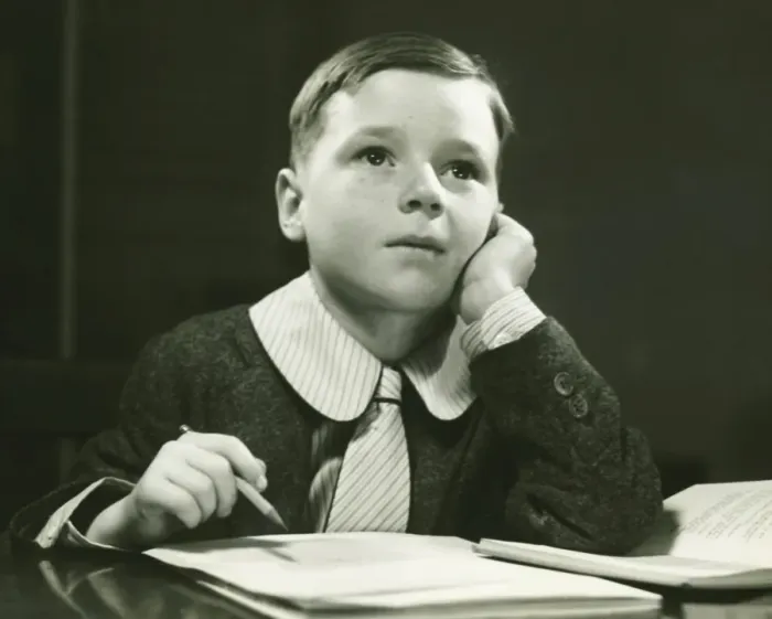 Framed Print : Boy (6-7) doing homework, (B&W), portrait Framed Print : Boy (6-7) doing homework, (B&W), portrait