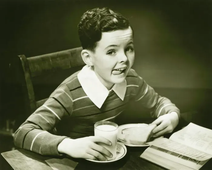 Framed Print : Boy (6-7) eating breakfast, (B&W), portrait Framed Print : Boy (6-7) eating breakfast, (B&W), portrait