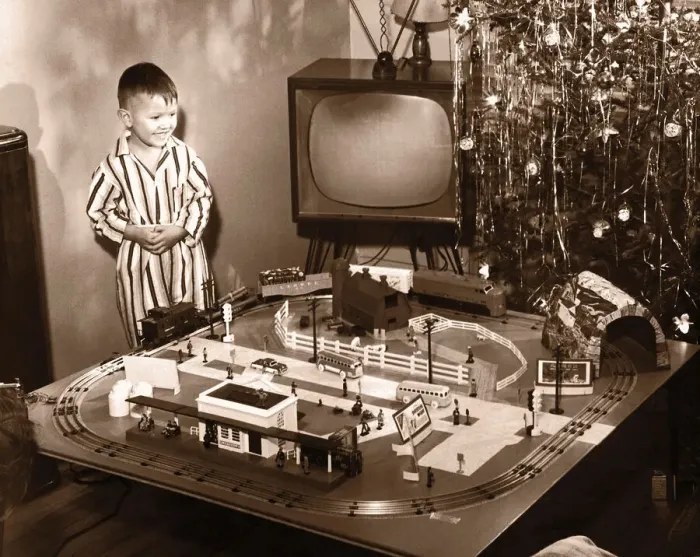 Framed Print : Boy (6-8) looking at model train set on Christmas Day(B&W sepia tone) Framed Print : Boy (6-8) looking at model train set on Christmas Day(B&W sepia tone)