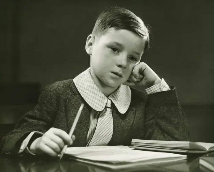 Framed Print : Boy (8-9) doing homework, (B&W), portrait Framed Print : Boy (8-9) doing homework, (B&W), portrait