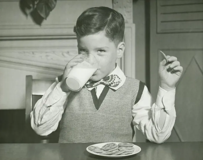 Framed Print : Boy (8-9) drinking glass of milk, sitting at table, (B&W), close-up Framed Print : Boy (8-9) drinking glass of milk, sitting at table, (B&W), close-up
