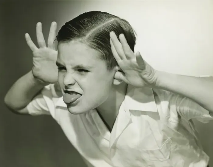 Framed Print : Boy (8-9) making face in studio, (B&W) Framed Print : Boy (8-9) making face in studio, (B&W)