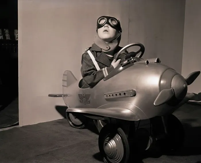 Framed Print : Boy in Aviator Suit Sitting in Toy Plane Framed Print : Boy in Aviator Suit Sitting in Toy Plane