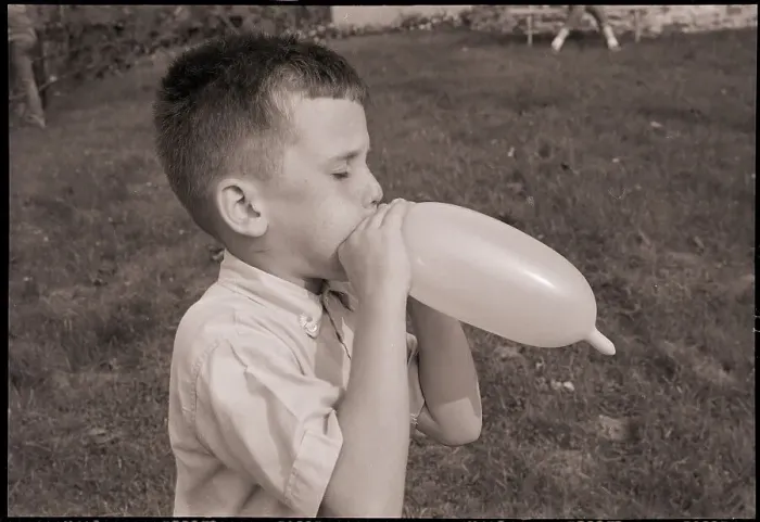 Framed Print : Boy Blowing a Balloon Framed Print : Boy Blowing a Balloon