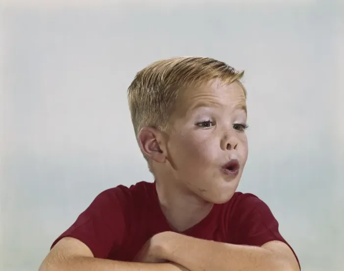 Framed Print : Boy blowing, close-up Framed Print : Boy blowing, close-up